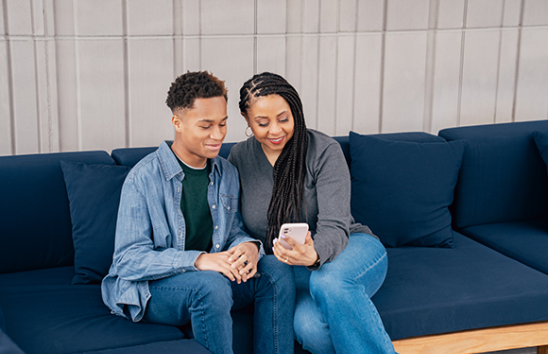 mother and son looking at phone